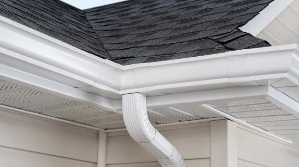 White seamless gutter and downspout installed on residential roof in South Central Tennessee