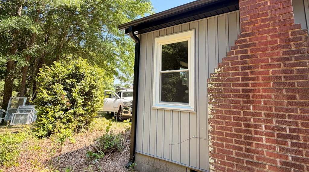 New gutter and downspout installation on residential siding in South Central Tennessee
