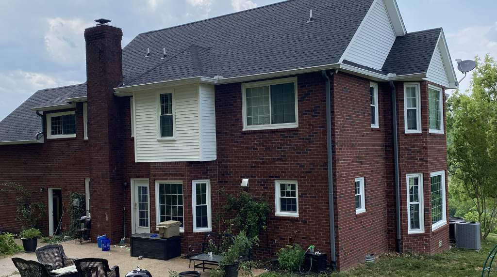 Gutter and downspout system installed on brick home for proper water drainage