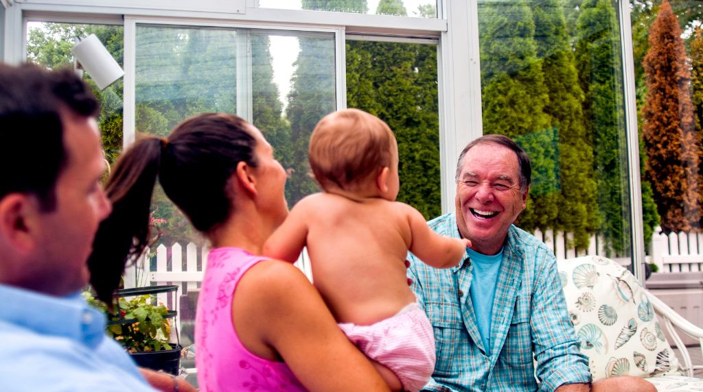 Family enjoying bug-free outdoor living inside a screened patio enclosure in South Central Tennessee