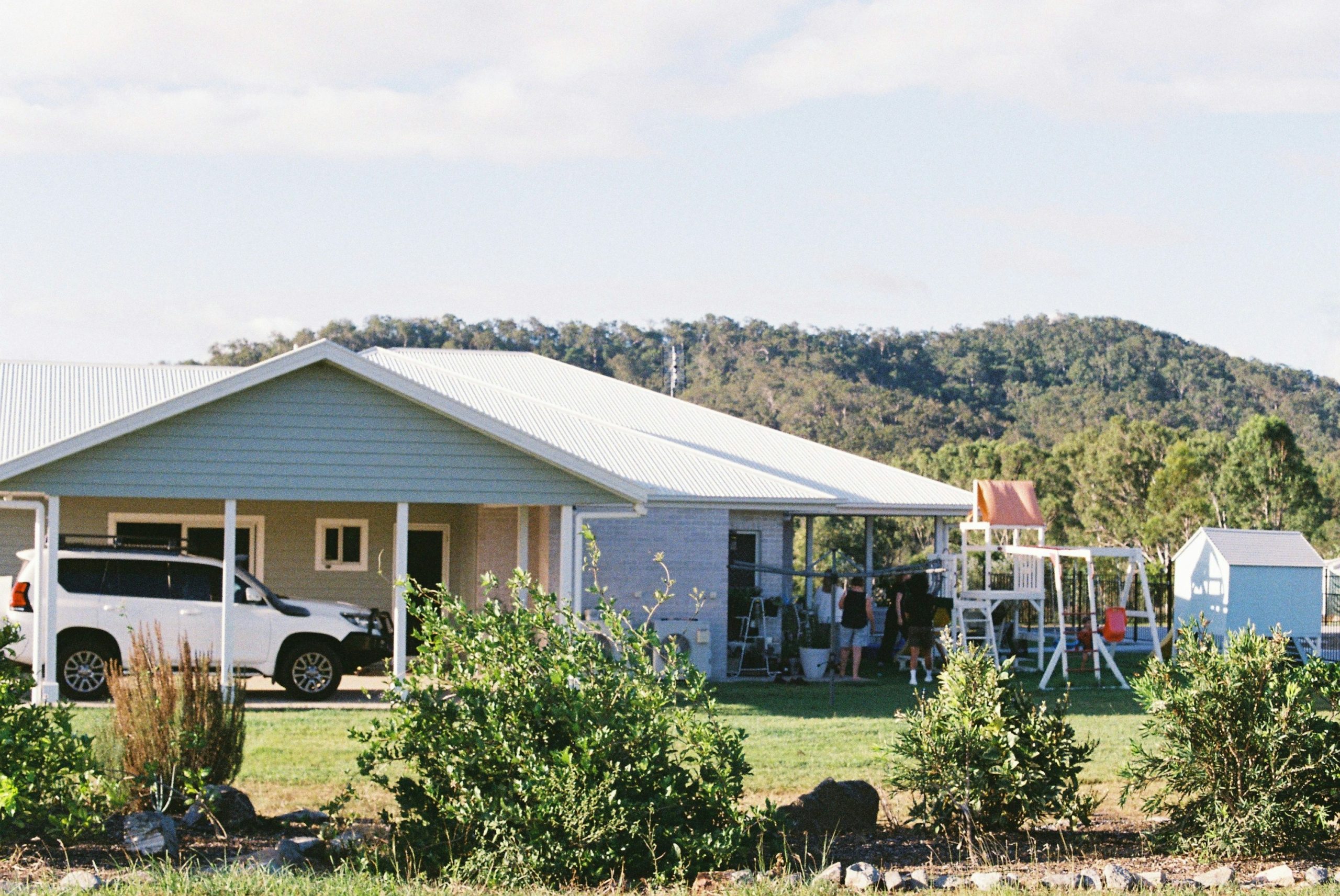 Choice Home Warranty review image of a family standing outside a typical suburban home.