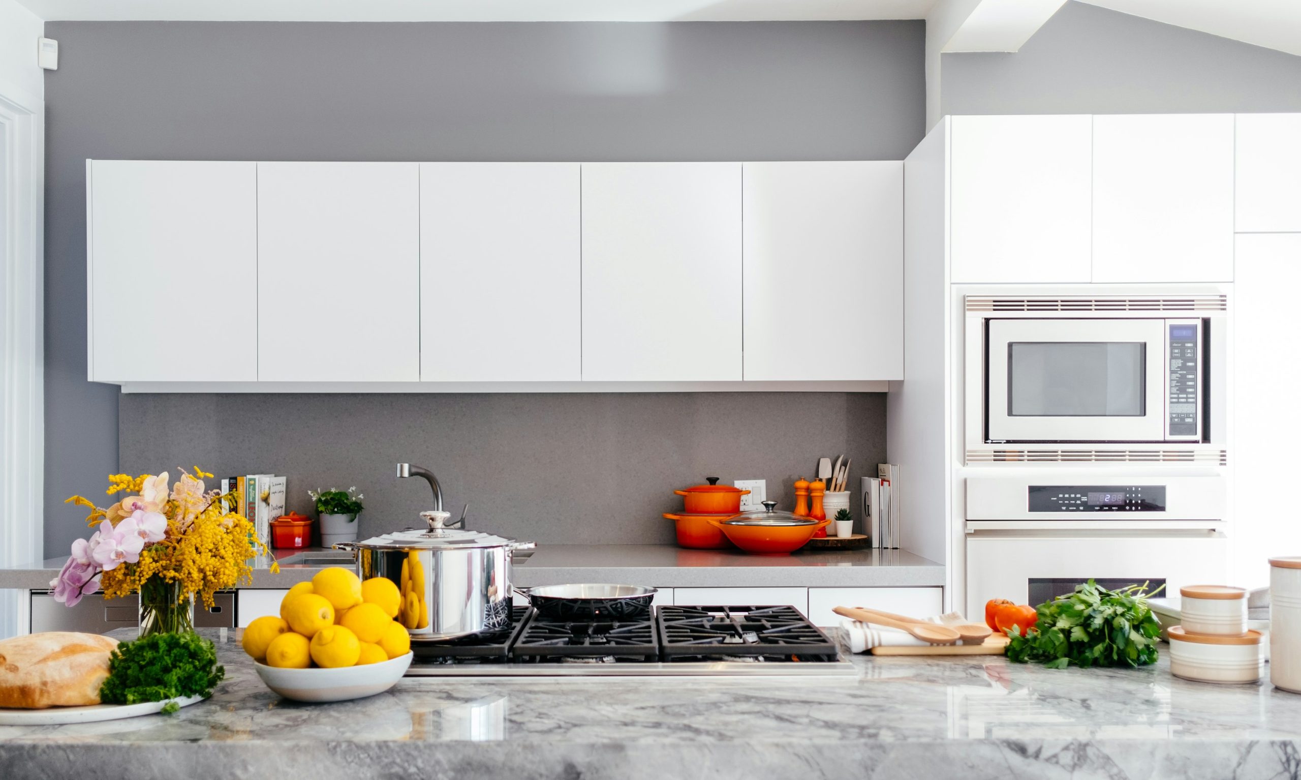 Home warranty plans image showing modern kitchen appliances in a clean home.
